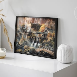 Op de afbeelding: Een ingelijste rechthoekige kunstdruk met een gedetailleerd landschapsschilderij van een nederzetting in elfenstijl met stenen bruggen, watervallen en herfstkleurig gebladerte. Het kunstwerk zit in een dunne zwarte lijst en toont de tekst ARONJA ART.