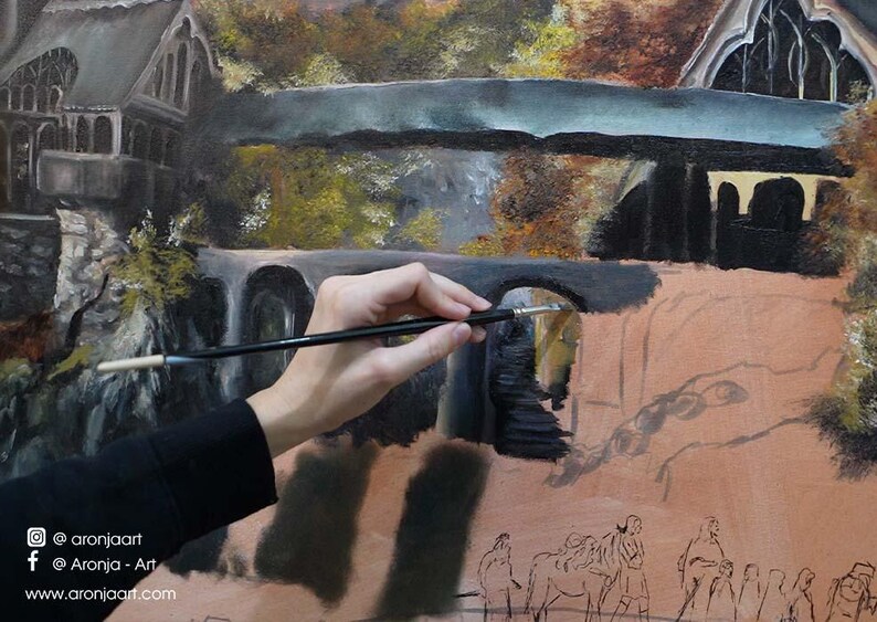 Op de afbeelding: Een olieverfschilderij in wording met een stenen brug en architecturale structuren in donkergrijze, bruine en aardse tinten. Een dun penseel wordt tegen het doek gehouden, dat onderaan een schets van figuren en social media tekst bevat.