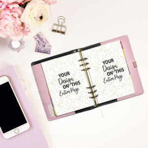 May include: A pink six-ring binder open to two pages featuring a gold confetti pattern and the black text "YOUR Design ON THIS Entire Page" printed on both sides. The binder has a black spine and internal pockets, with a smartphone nearby.