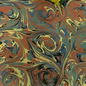 May include: Abstract marbled paper with swirling patterns in shades of red, blue, green, black, and yellow.