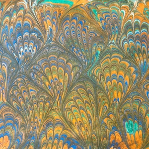 May include: Abstract marbled paper with a peacock feather design in shades of blue, green, orange, and brown.
