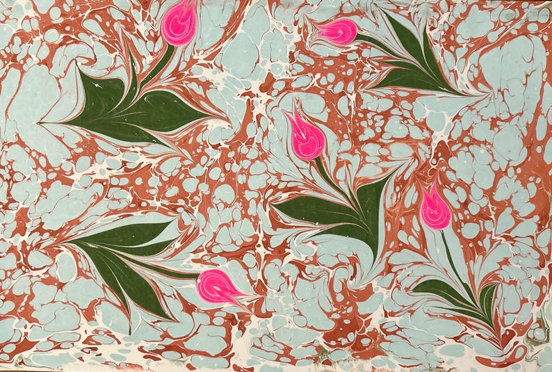May include: Abstract marbled paper with a swirling pattern of blue, white, and brown. Five pink tulips are scattered throughout the design.