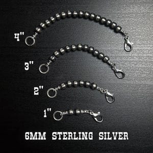 May include: Four sterling silver beaded chain extenders, 1 to 4 inches long, with lobster claw clasps and jump rings. The text "6MM STERLING SILVER" is displayed below the extenders.
