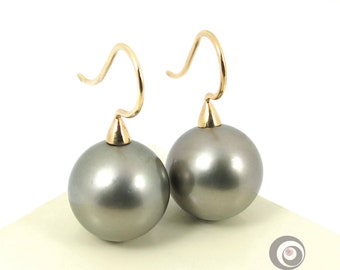 May include: A pair of gray pearl drop earrings with gold hooks.
