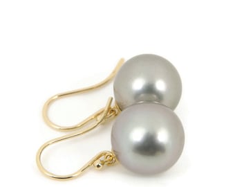 May include: A pair of silver pearl earrings with gold hooks.