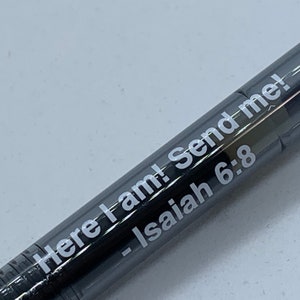 May include: A black pen with white lettering that reads "Here I am! Send me! - Isaiah 6:8"