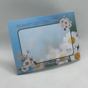 May include: A blue and white card with a white daisy border. The card says "I'm Sorry That I Missed You!" and "Please Visit JW.ORG".