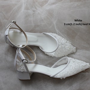 May include: White bridal shoes with a lace design and a 3 cm (1.2 inch) heel height.