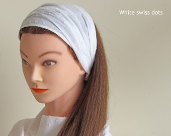 May include: White headband with small white dots. The headband is made of a soft, stretchy fabric and is perfect for keeping hair out of your face.