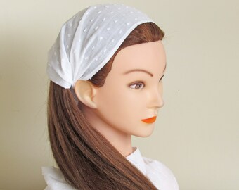 May include: White cotton headband with a dotted pattern. The headband is folded and tied around the head.