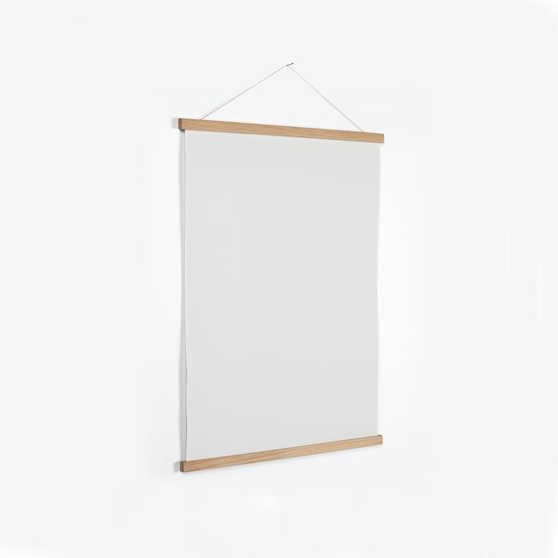 May include: A wooden poster hanger with a white canvas hanging from it. The hanger has a simple design and is made of natural wood.