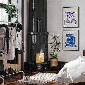 a bedroom with a bed, a chair, and a fireplace