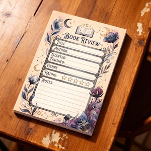 May include: A book review notepad with a floral and celestial design. The notepad has sections for title, author, and genre, with a rating section and space for notes. The design includes moons, stars, and flowers in blue, purple, and gold, on a cream background.