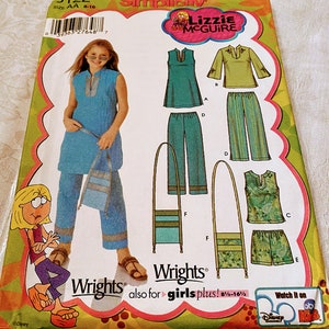 May include: A sewing pattern for a girl's outfit, featuring a green and blue top and pants, a green and white top and shorts, and a green top with long sleeves. The pattern is from Simplicity and is for sizes 8-16. The pattern also includes instructions for making a matching bag.