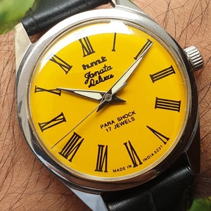 Reloj de pulsera vintage HMT Janata Deluxe con números romanos, cuerda manual y 17 joyas.
