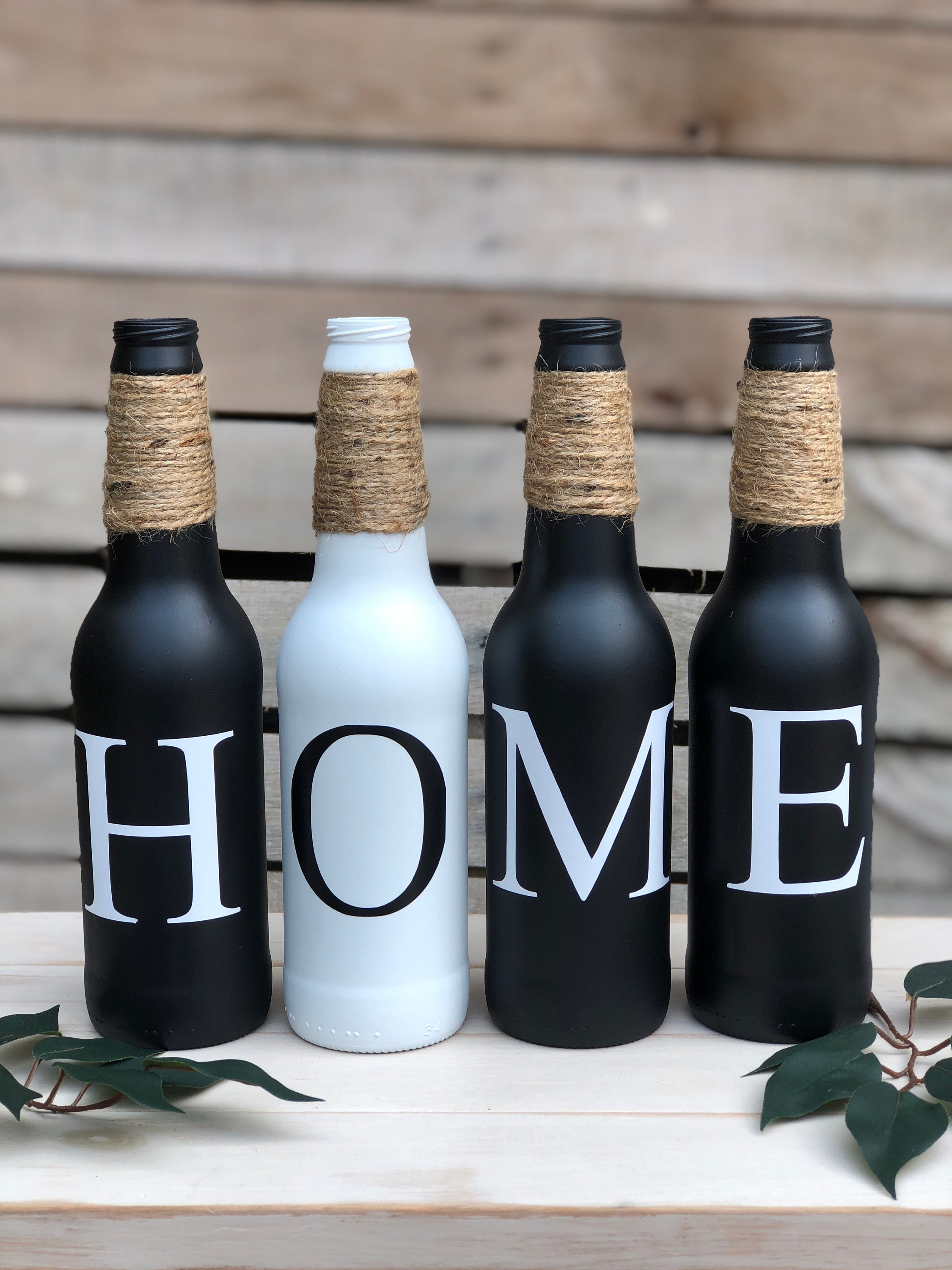 The image shows a collection of beautifully decorated bottles, each with a unique design and color scheme. The intricate patterns and vibrant colors create a visually stunning display that would make a perfect addition to any home decor or special event.