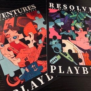 May include: Two colorful playbills for a play called "Adventures of the Great Ace Attorney" and "Resolve the Great Ace Attorney". The playbills are made to look like jigsaw puzzles with images of the characters from the play.