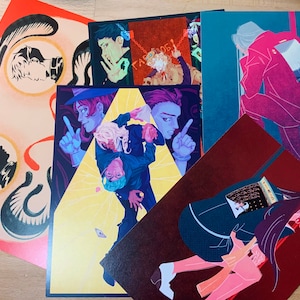 May include: Five illustrated postcards featuring different characters and scenes. The postcards are colorful and feature a variety of styles, including anime, manga, and graphic novel.