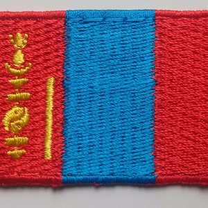May include: A red, blue, and yellow embroidered patch featuring the national flag of Mongolia. The patch is rectangular and has a stitched border.