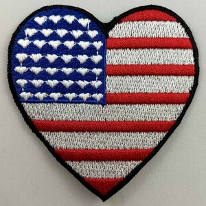 May include: A red, white and blue embroidered heart-shaped patch with the American flag design.