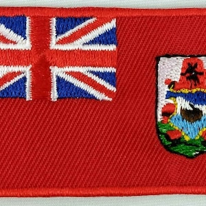 Könnte beinhalten: Ein gestickter Aufnäher mit der Flagge von Bermuda. Die Flagge zeigt im oberen linken Eck eine Union Jack und im unteren rechten Eck das Wappen von Bermuda.