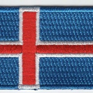 May include: A blue, white, and red embroidered patch of the Icelandic flag.