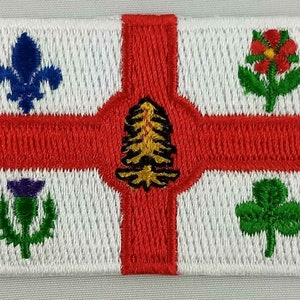 May include: Embroidered patch featuring a white background with a red cross. The cross is decorated with four symbols: a blue fleur-de-lis, a green shamrock, a purple thistle, and a gold pine tree.