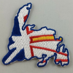 May include: Embroidered patch shaped like the outline of the island of Newfoundland, Canada. The patch is white with a red, yellow, and blue design that resembles the flag of Newfoundland and Labrador.