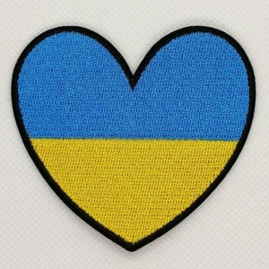 May include: A blue and yellow heart-shaped patch with the colors of the Ukrainian flag.