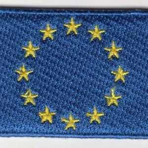 May include: A blue fabric patch with a circle of 12 yellow stars. The stars are arranged in a circle around the center of the patch.