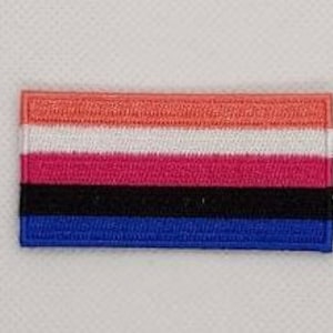 May include: A rectangular embroidered patch with five horizontal stripes in the colors orange, white, pink, black, and blue.