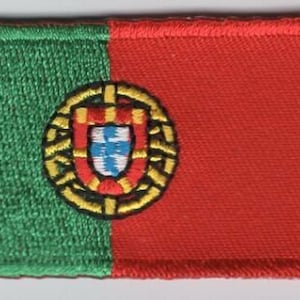 May include: A green and red embroidered patch with the coat of arms of Portugal in the center.