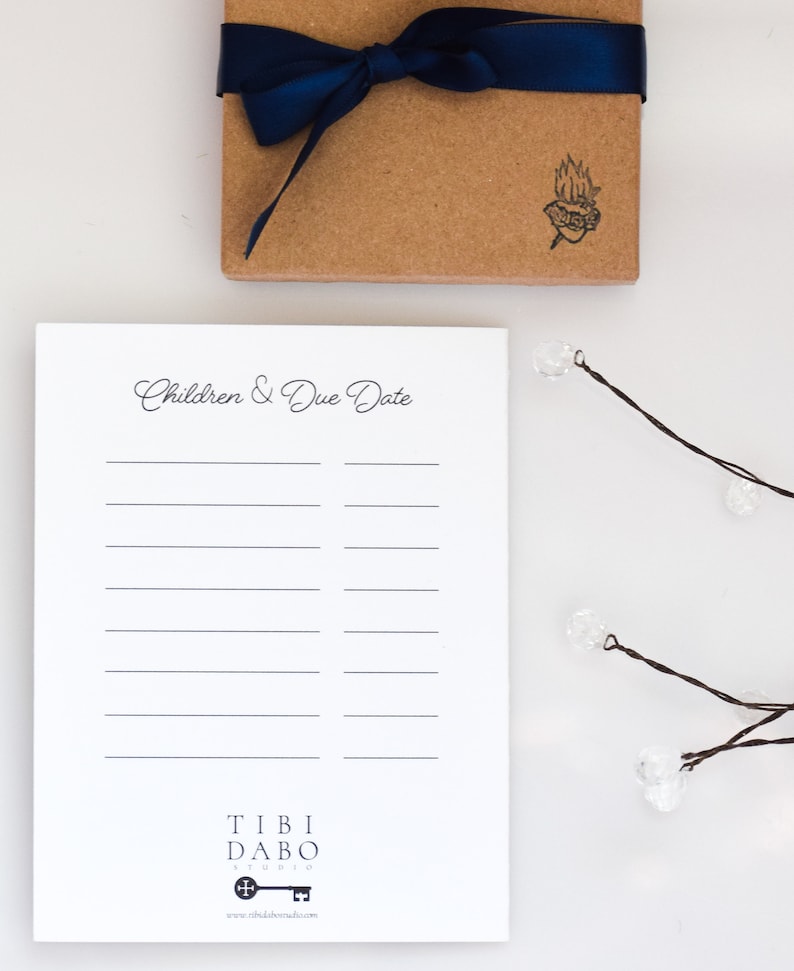 May include: A white notepad with a black line design and the text "Children & Due Date" at the top. The notepad has a black and white logo at the bottom that says "Tibi Dabo Studio" with a key icon and the website address "www.tibidabostudio.com".