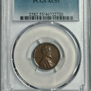 May include: A 1927-S Lincoln Wheat Penny graded AU55 by PCGS in a plastic slab with a label that reads "PCGS AU55" and "2582.55/46722720".