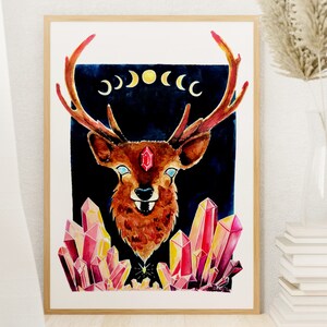 May include: A watercolor painting of a deer with a red gemstone in its forehead, surrounded by pink and yellow crystals. The deer has large antlers and is set against a dark blue background with a crescent moon design.