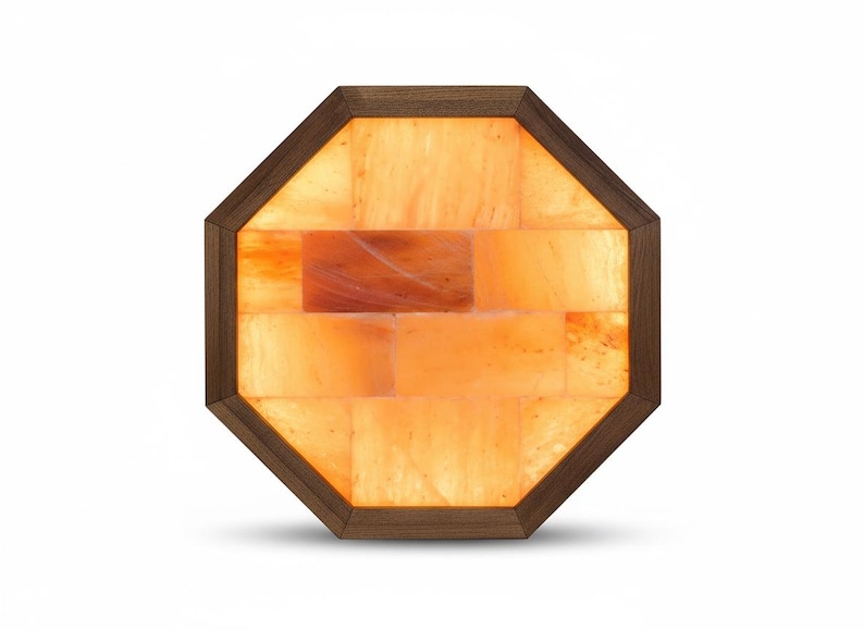 May include: An octagonal Himalayan salt lamp with a wooden frame. The lamp is filled with orange-colored salt bricks, creating a warm, inviting glow. The wooden frame is a dark brown color.