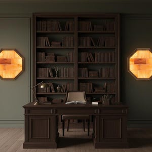 May include: A dark wood desk with a matching chair sits in front of a large bookshelf filled with books. Two octagonal wall sconces with a warm orange glow flank the bookshelf. A brass desk lamp is on the desk.
