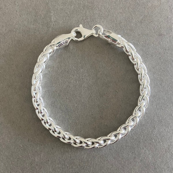 May include: A silver chain bracelet with a lobster clasp.