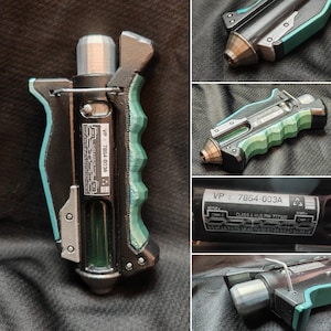 May include: A futuristic device in black, teal, and silver. The handle has a textured teal grip. The device has the text "VP: 7864-003A" and other technical details. The nozzle is bronze-coloured.