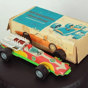 Toy car with inertial mechanism Retro toy racing car made in the USSR in the 1990s. In original packaging. Not used.