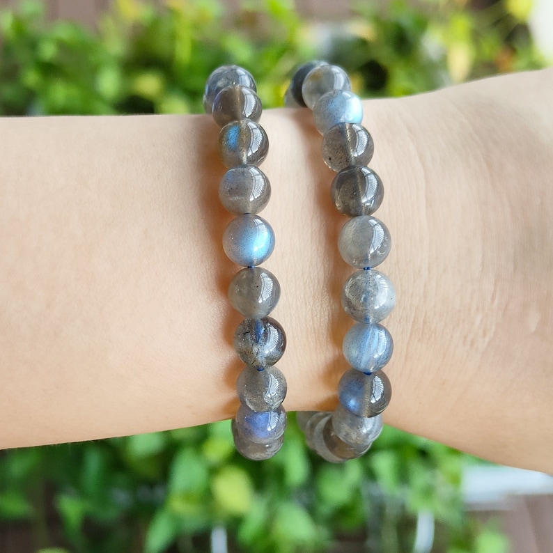 May include: Two labradorite gemstone bracelets with iridescent blue and gray beads.