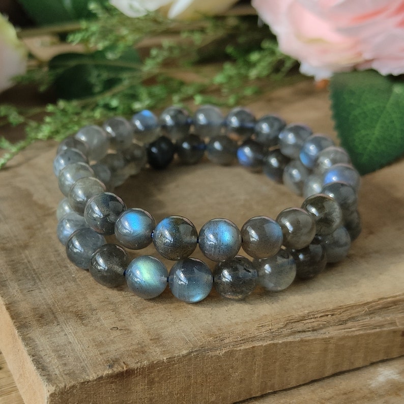 May include: Two layered bracelets made of dark gray labradorite beads with iridescent blue and green flashes.