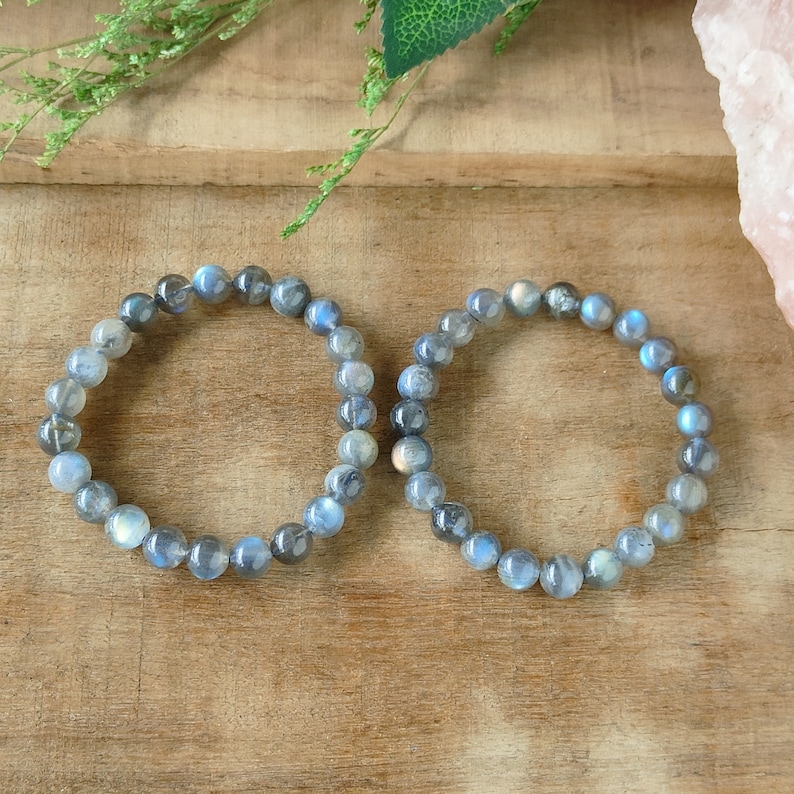 May include: Two labradorite gemstone bracelets with iridescent blue and grey beads.