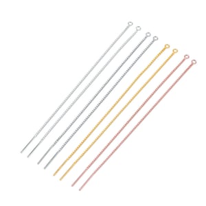 May include: A selection of threader earrings in silver, gunmetal, gold, and rose gold. The earrings feature a fine chain design with a small loop at the top and a straight bar at the bottom. They are presented against a white backdrop.