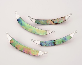 May include: Four iridescent abalone shell crescent shaped pendants with silver jump rings. The pendants are a mix of green, blue, and purple.