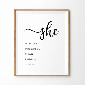 May include: A black and white printable wall art print with the text "she is more precious than rubies #Proverbs 3:15"