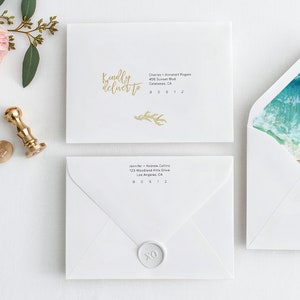 May include: White envelopes with gold lettering and a watercolour ocean design. One envelope reads "Kindly deliver to" with an address. Another envelope has a wax seal with "XO". A gold wax stamp and a pink stamp are also visible.