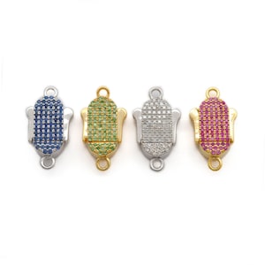 Pode incluir: Quatro fechos de joias decorativos em tons de prata e ouro. Cada fecho apresenta uma secção oval central incrustada com pequenas pedras preciosas coloridas. As pedras preciosas são azuis, verdes, transparentes e rosas. Os fechos têm uma argola em cada extremidade.