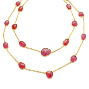 May include: A gold chain necklace with pink gemstone beads. The necklace is layered with two strands of chain and has a total of 14 beads.