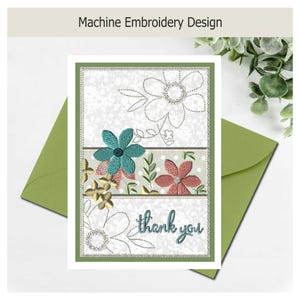 May include: A rectangular greeting card featuring a machine embroidery design with teal and coral flowers, green leaves, and the text thank you in teal script. The card has a white background with a subtle floral pattern and a green border.